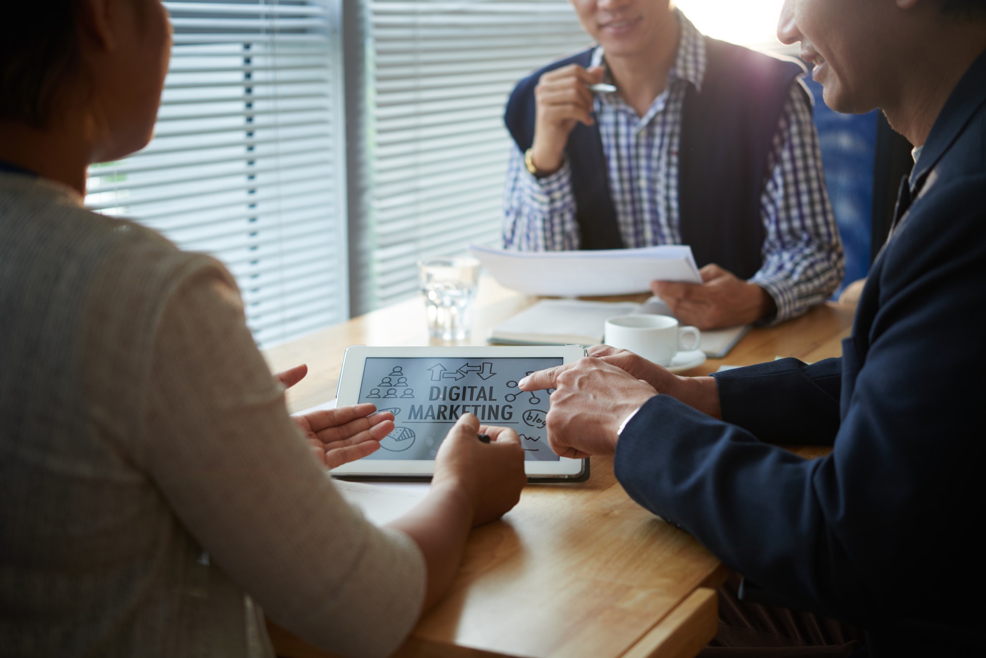 A team of diverse individuals collaborating on a digital marketing strategy for medical website design, medical search engine optimization, healthcare email design, healthcare social media marketing, medical videography and photography, and medical blog writing.